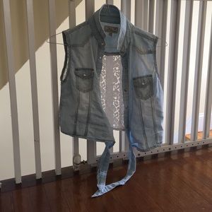 This is a cute button up denim vest with buttons.