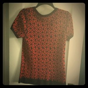 A short sleeve red and navy sweater.