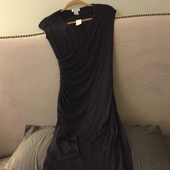 Tags still on purple fitted dress