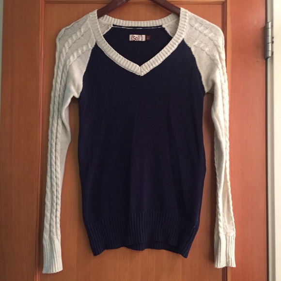 Blue sweater with cream sleeves.