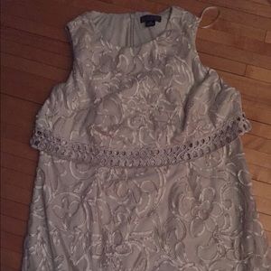 Cream/Ivory colored. Hits just above the Knee.