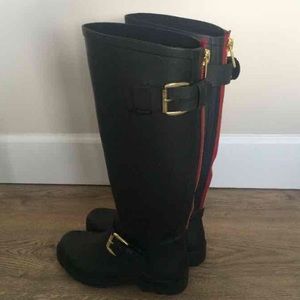 Black rain boots with gold/red details