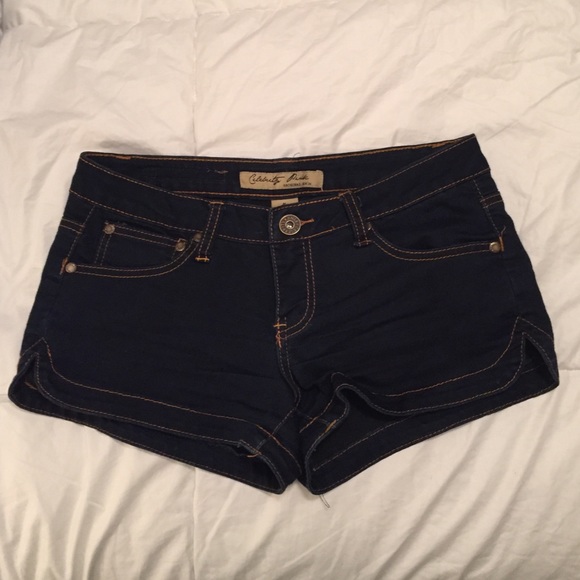 Dark wash denim booty shorts.