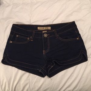 Dark wash denim booty shorts.