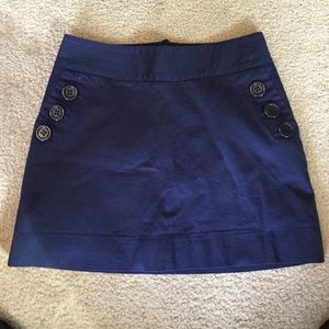 Dark Blue Mini Skirt with button-up side pockets.