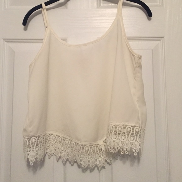 off white cropped tank with lace at the bottom.