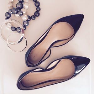 Black patent leather flats with gold trim base
