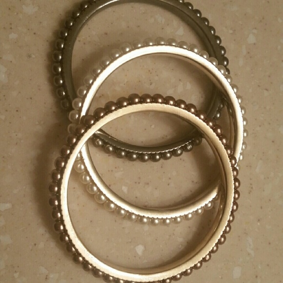 Three multi colored bangle brackets.