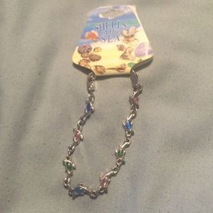 A bracelet with dolphins on it.