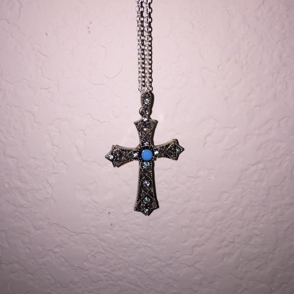 Medium length turquoise cross necklace.