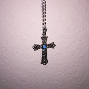 Medium length turquoise cross necklace.