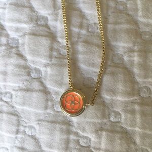Kendra Scott peach logo pendent.