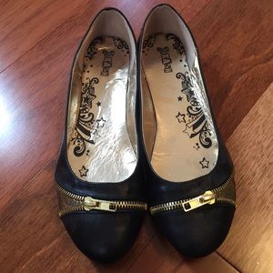 black flats with gold zippers and sparkles