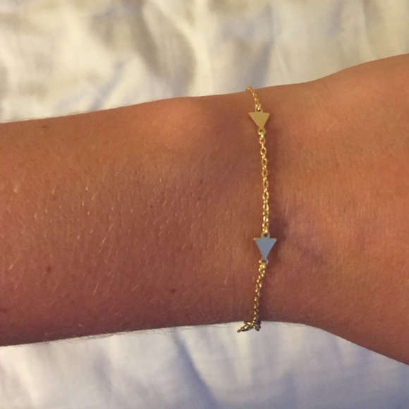 Gold bracelet w/ triangles & a small maroon tassel