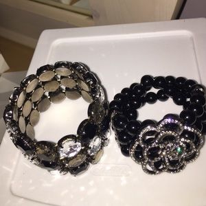 2 black and silver bracelets