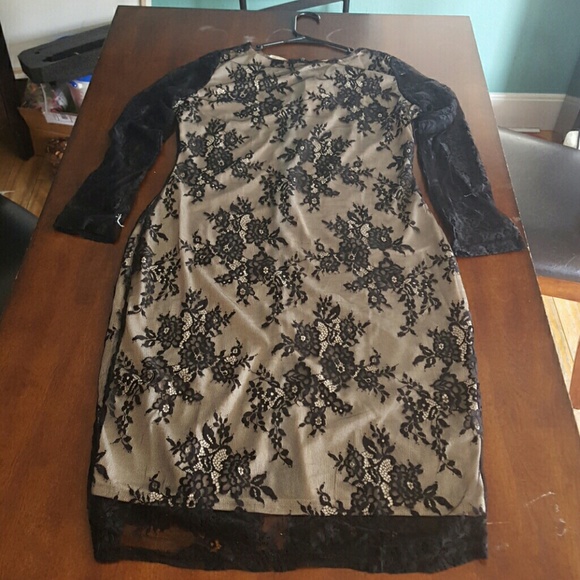 Sheer lace covering a silk cream colored underlay