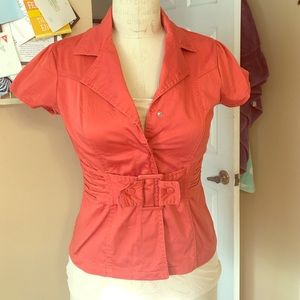 Orange short sleeve jacket top.