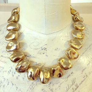 Gold bead (non-metal) necklace.