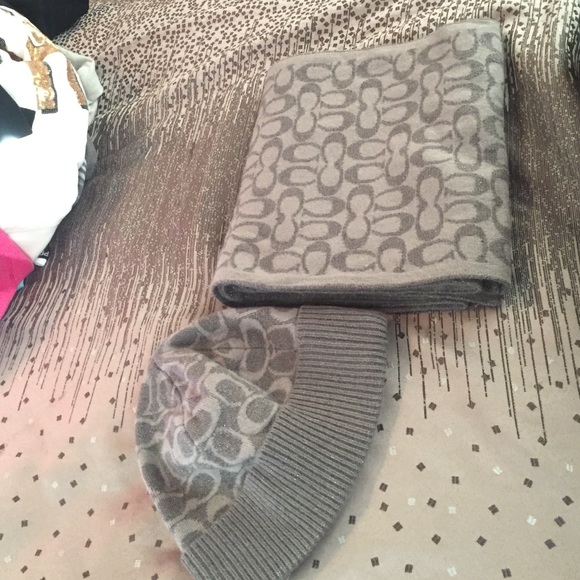 A silver/grey coach scarf and hat.