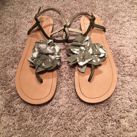 Dark gray sandals with a cloth flower detail.