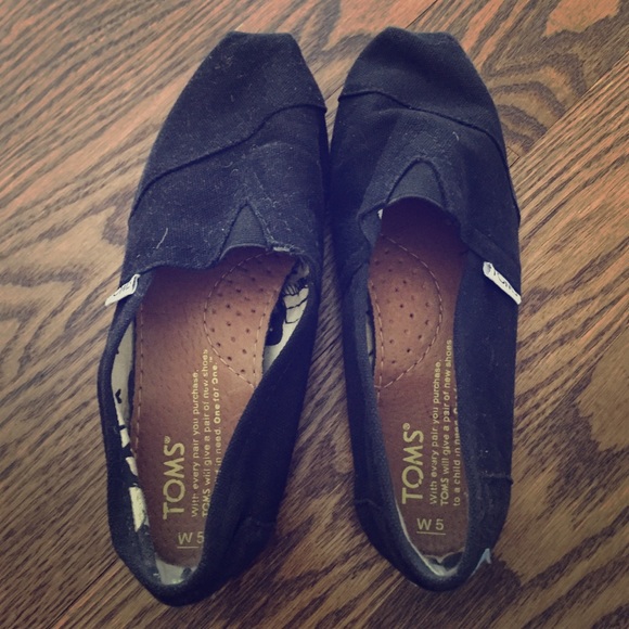 Black TOMS slip-ons