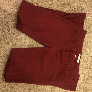 Maroon skinny jeans.