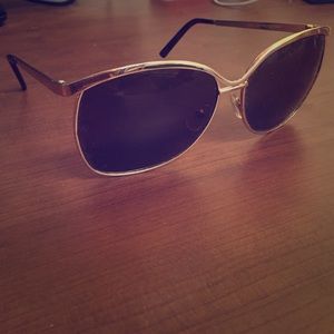 Gold-rimmed, large lens sunglasses