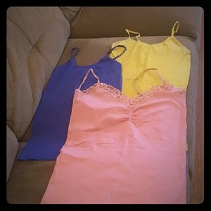 3 tank tops blue, yellow, and pink