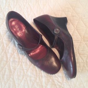 Burgundy Mary Jane wedges with button detail.