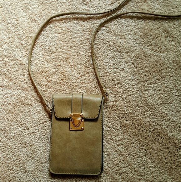 Tan leather  crossbody bag (holding)