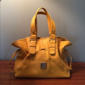 Yellow Dooney and Bourke drawstring purse.