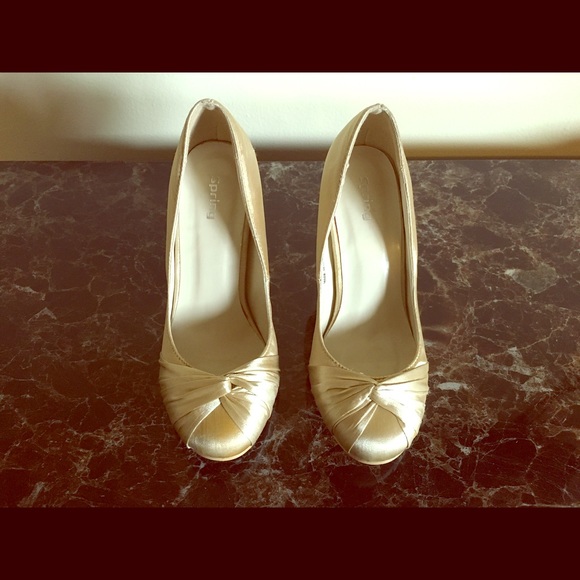Gold high heeled shoes