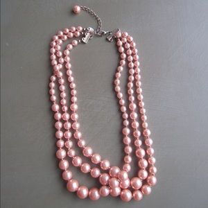 Peach colored multi strand pearl necklace