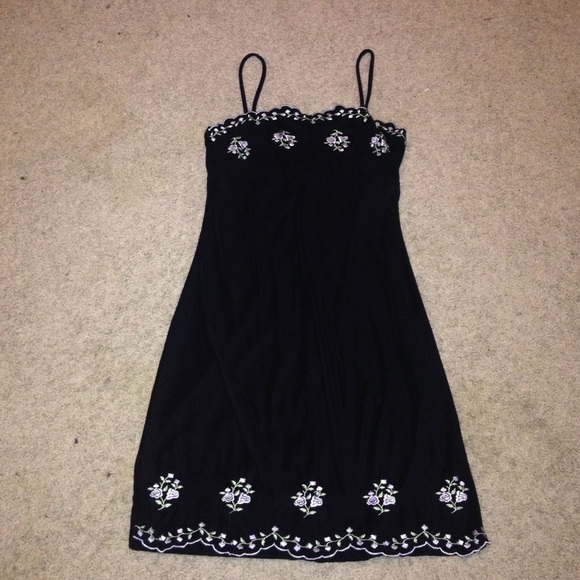 Cute little black dress with embroidered flowers.