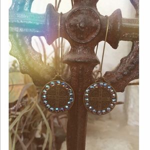 Medallion like long loop earrings.