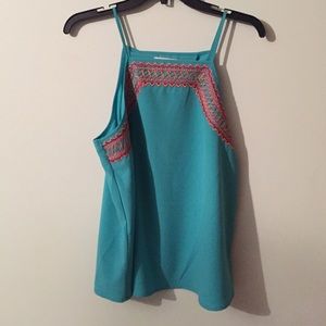 I am selling a turquoise tank top by Gianni binni