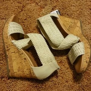 Cream colored wedges with criss-cross straps