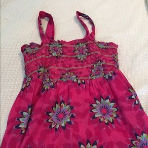 Cute fuchsia top with straps.