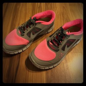 Pink and grey Nike Free Run tennis shoes
