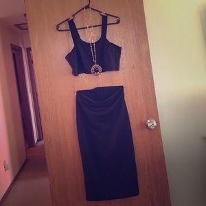 A two piece top and skirt with necklace