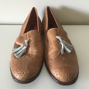 Light brown leather loafers with blue tassels