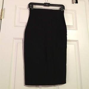 High pencil skirt. Knee length.