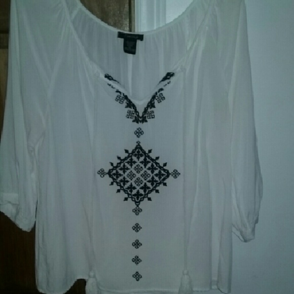 White blouse with blue design and tassels