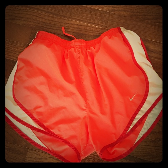Neon orange Nike running shorts