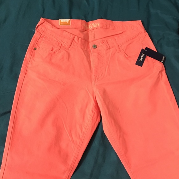 A pair of neon orange Old Navy Rock Star jeans