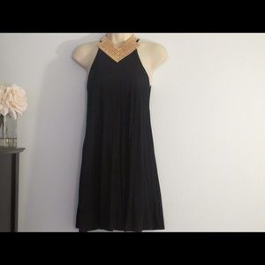 Black trapeze dress with gold necklace / earrings