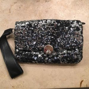 Black sequin clutch by Jennifer Lopez.