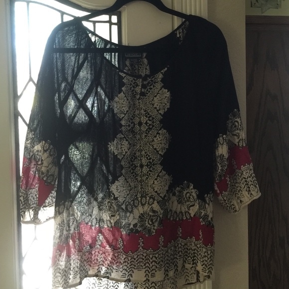 Beautiful semi sheer blouse.  100% rayon.