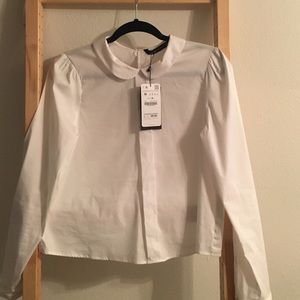 White blouse with PeterPan style collar.