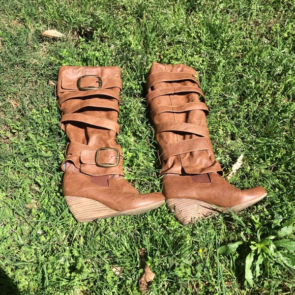 Tall brown leather boots with buckles